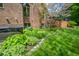 Charming backyard with a hot tub, manicured gardens, and a brick home exterior for serene outdoor living at 5851 Beisinger Pl, Indianapolis, IN 46237