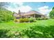 Expansive backyard featuring a deck, brick patio, and lush landscaping for outdoor enjoyment at 5851 Beisinger Pl, Indianapolis, IN 46237