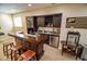 Basement bar area with seating, cabinetry, stainless steel appliances, and a popcorn machine at 5851 Beisinger Pl, Indianapolis, IN 46237