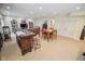 Open basement area with a bar, dining table, and a door to another room at 5851 Beisinger Pl, Indianapolis, IN 46237