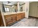 Bathroom featuring double sinks with wooden cabinets and a large mirror at 5851 Beisinger Pl, Indianapolis, IN 46237