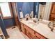 Blue bathroom with a single sink vanity and tile floors at 5851 Beisinger Pl, Indianapolis, IN 46237