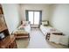 Cozy bedroom with twin beds, ample natural light, and charming decor at 5851 Beisinger Pl, Indianapolis, IN 46237