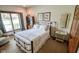 Comfortable bedroom featuring a wrought iron bed, soft carpet, and a window at 5851 Beisinger Pl, Indianapolis, IN 46237