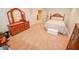 Bedroom with carpet, dresser, mirror, and neutral-toned walls and white trim at 5851 Beisinger Pl, Indianapolis, IN 46237