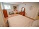 Bright bedroom with a window, dresser, white walls, and neutral carpet at 5851 Beisinger Pl, Indianapolis, IN 46237