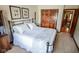 Cozy bedroom with a black iron bed frame, carpet flooring, and access to ensuite bathroom at 5851 Beisinger Pl, Indianapolis, IN 46237