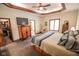 Bright bedroom featuring tray ceilings, a ceiling fan, natural light, and an expansive closet space at 5851 Beisinger Pl, Indianapolis, IN 46237