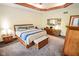 Bedroom featuring tray ceilings, a ceiling fan, natural light, and light beige colored walls at 5851 Beisinger Pl, Indianapolis, IN 46237