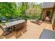 Expansive deck with dining area, lounge chairs, and lush greenery offers outdoor living space at 5851 Beisinger Pl, Indianapolis, IN 46237