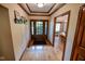 Home entryway with hardwood flooring, coat rack and a view of the dining room at 5851 Beisinger Pl, Indianapolis, IN 46237