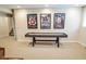 Finished basement game room area with framed movie posters and a shuffleboard table for recreation at 5851 Beisinger Pl, Indianapolis, IN 46237