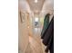 Hallway leading to a bright, airy space with neutral walls and tiled floor at 5851 Beisinger Pl, Indianapolis, IN 46237