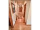 Inviting hallway with hardwood floors, neutral walls, and wood trim at 5851 Beisinger Pl, Indianapolis, IN 46237