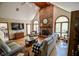 Bright living room with a brick fireplace, and hardwood floors at 5851 Beisinger Pl, Indianapolis, IN 46237