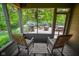 Inviting screened porch offers outdoor views of a deck and landscaped yard through screened walls at 5851 Beisinger Pl, Indianapolis, IN 46237