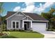 Charming home showcasing shingle and horizontal siding, a covered porch, and an attached two-car garage at 588 Bluestem Ln, New Whiteland, IN 46184