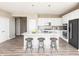 Modern kitchen with stainless appliances, a large island with seating, white cabinetry, and a stylish backsplash at 588 Bluestem Ln, New Whiteland, IN 46184