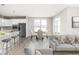 Bright, open-concept space blending kitchen, dining, and living areas, featuring modern finishes and a neutral color palette at 588 Bluestem Ln, New Whiteland, IN 46184