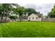 Expansive backyard featuring a well-maintained lawn, shed, firepit and privacy fence at 6137 Evanston Ave, Indianapolis, IN 46220