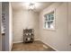 Bright dining nook offers a modern brick accent wall, stylish lighting, and seamless kitchen access at 6137 Evanston Ave, Indianapolis, IN 46220
