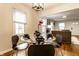 Elegant dining area with a glass table, stylish chairs, and plenty of natural light from the windows at 6137 Evanston Ave, Indianapolis, IN 46220