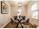 Modern dining room with a glass-top table, sleek chairs, hardwood floors, and natural light at 6137 Evanston Ave, Indianapolis, IN 46220