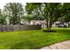 This home features a well manicured front lawn and a long fenced in backyard at 6137 Evanston Ave, Indianapolis, IN 46220