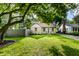 Beautiful lawn, mature trees, stone and siding exterior create a welcoming facade at 6137 Evanston Ave, Indianapolis, IN 46220