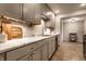 Updated kitchen features marble countertops, stainless steel appliances, and soft gray cabinetry at 6137 Evanston Ave, Indianapolis, IN 46220