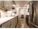 Well-lit kitchen boasts stainless appliances, marble countertops, and access to a charming dining area at 6137 Evanston Ave, Indianapolis, IN 46220