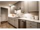 Stylish kitchen featuring marble counters, stainless appliances and grey cabinetry with under-cabinet lighting at 6137 Evanston Ave, Indianapolis, IN 46220