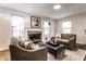 Bright living room featuring a stone fireplace, hardwood floors, and comfortable seating at 6137 Evanston Ave, Indianapolis, IN 46220