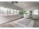 Light-filled sunroom featuring many windows, a screened door and a patterned rug at 6137 Evanston Ave, Indianapolis, IN 46220