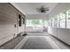 The sunroom features a ceiling fan, many windows, and a neutral colored rug at 6137 Evanston Ave, Indianapolis, IN 46220