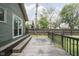 Large back deck with dark stain, surrounded by a lush lawn and privacy fence at 6159 Broadway St, Indianapolis, IN 46220