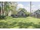 Large backyard with a well-maintained lawn and a deck perfect for entertaining at 6159 Broadway St, Indianapolis, IN 46220