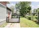 A side view of a raised wooden deck and a well-maintained backyard at 6159 Broadway St, Indianapolis, IN 46220