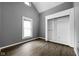 A primary bedroom with vaulted ceilings, a large window, and a sizable closet at 6159 Broadway St, Indianapolis, IN 46220