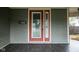Close-up of the front door on a charming front porch with a painted wood floor at 6159 Broadway St, Indianapolis, IN 46220