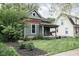 View of a quaint home with a well-manicured lawn and inviting front porch swing at 6159 Broadway St, Indianapolis, IN 46220