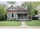 Charming exterior of a two-story home featuring a covered porch and inviting curb appeal at 6159 Broadway St, Indianapolis, IN 46220