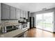 Functional kitchen featuring stainless steel appliances and gray cabinets at 6159 Broadway St, Indianapolis, IN 46220