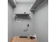 A utility room with gray painted walls, plywood floors, and simple storage at 6159 Broadway St, Indianapolis, IN 46220