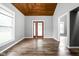 Open living room with gorgeous wood ceiling and hardwood floors at 6159 Broadway St, Indianapolis, IN 46220