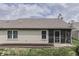 Exterior home view with siding, a screened-in porch, manicured lawn, and a welcoming backyard space at 6503 E Walton Dr, Camby, IN 46113