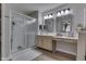 Bright bathroom with a glass shower, double mirrors, and light wood cabinets at 6503 E Walton Dr, Camby, IN 46113