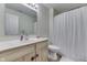 Bright bathroom featuring a sink, toilet, vanity with storage, and shower with curtain at 6503 E Walton Dr, Camby, IN 46113
