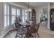 Charming dining area featuring large bay windows with shutter blinds and hardwood floors at 6503 E Walton Dr, Camby, IN 46113