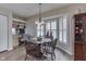 Cozy dining area with bay windows, shutter blinds, modern lighting, and a hardwood floor at 6503 E Walton Dr, Camby, IN 46113
